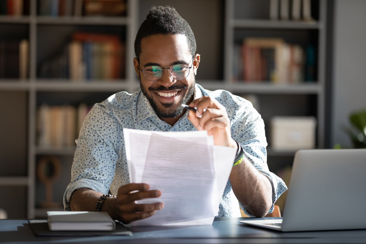 Educators reads from papers while smiling Educators reads from papers while smiling